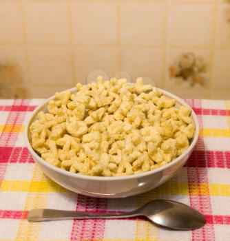 Dry breakfast as asterisks in white bowl. Shallow depth of field.