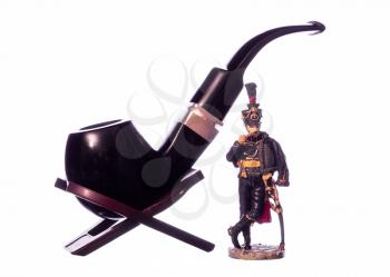 Hussars figurine, smoking his pipe beside a big pipes.