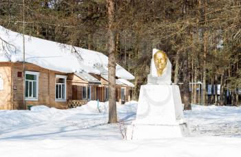 Old rural hospital. Nearby there is a monument to Vladimir Ilyich Lenin. Russia.