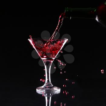 red splashing cocktail on black. 