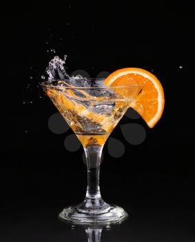 Vermouth cocktail inside martini glass over dark background