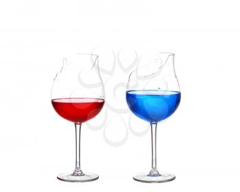 Two broken glasses with red and blue cocktail on white isolate