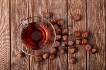 Autumn harvest. nuts on a dark recycled wood background, with copy space .. Top view of tea, nuts