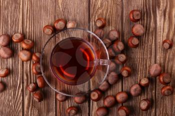 Autumn harvest. nuts on a dark recycled wood background, with copy space .. Top view of tea, nuts