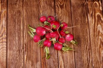 Radish on wooden background top view 