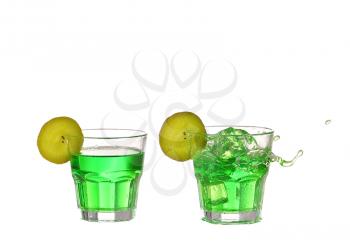Fruit cocktail with lime and ice cubes in a glass on white background.