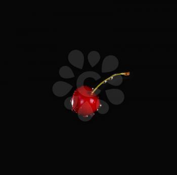Cherry with water drops over black background