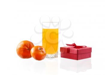 Orange juice in a glass with lime, orange, tangerine box