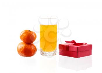 Orange juice in a glass with lime, orange, tangerine box