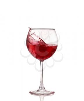 red wine swirling in a goblet wine glass, isolated on a white background