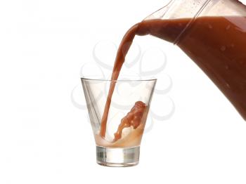 Pouring cocoa into a glass isolated over white background. Chocolate cocktail