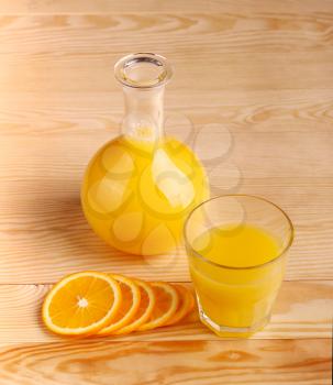 Fresh Orange juice with sliced fruit on the wood background