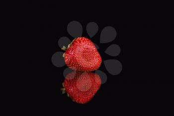 Red strawberries against dark background