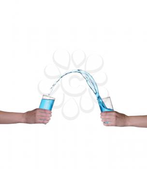 Blue water splashing in glass held by hand, white background