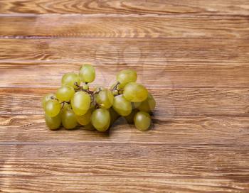 White grapes on wooden table, from above