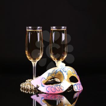 Champagne.New Year's Eve.Celebration. Female carnival mask with glass of champagne