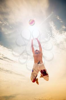 male beach volleyball game player jump on hot sand