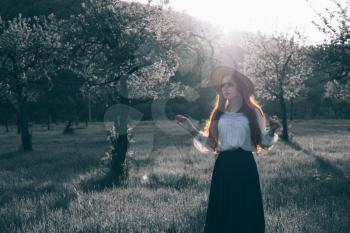 happy laughing girl holding straw walking in the green summer park