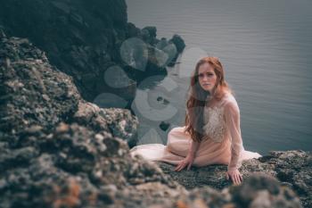 beautiful young girl in the morning under the water. Mysterious Woman in White Dress, vintage filter