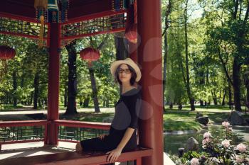 Young beautiful pregnant woman on a walk in the park of Warsaw, Poland. Lazienki