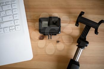 Work space on table of photographer. Minimal workspace with Laptop, camera and lens copy space on wooden background. Modern and elegant. Top view. Flat lay style. Close up