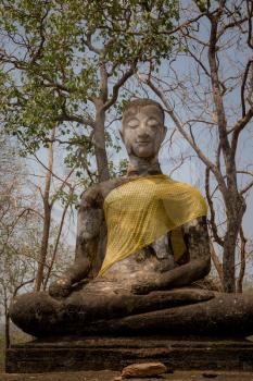 Si Satchanalai Historical Park Is the historical park of Thailand Built in the Sukhothai period Received cultural heritage registration From UNESCO. sitting buddha statue decorated with cloth