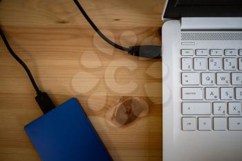 Work space on table of photographer. Minimal workspace with Laptop, camera and lens copy space on wooden background. Modern and elegant. Top view. Flat lay style. Close up