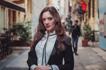 Beautiful stylish young latin woman walking the atmospheric streets of Istanbul, Turkey. The idea and concept of an interesting vacation, adventure in an amazing city