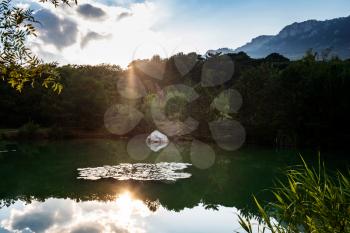 beautiful sunset on a mountain lake, suummer season. warm rays of sunset, details and atmosphere of the golden hour