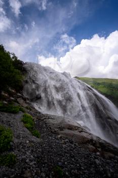 Beautiful powerful waterfall in the Caucasus Mountains. Alibeksky waterfall, Dombai, Russia