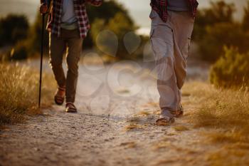 two men hikers enjoy a walk in nature, sunset time in summer. enjoying their adventure. Lifestyle hiking concept vacations outdoor