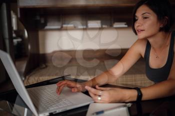 Young asian female student using laptop, communicates on internet. Cozy office workplace, remote work, E learning concept. closeup hands