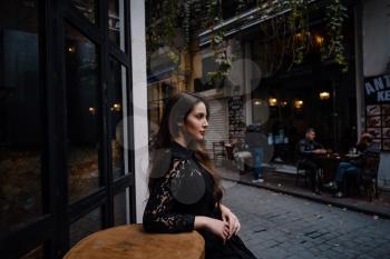 Beautiful woman walks at Istiklal street,a popular location in Beyoglu district,Istanbul,Turkey. walking on Istanbul street and enjoy arabic city architecture