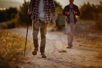 two men hikers enjoy a walk in nature, sunset time in summer. enjoying their adventure. Lifestyle hiking concept vacations outdoor