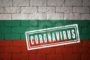 Flag of the Bulgaria with original proportions. stamped of Coronavirus. brick wall texture. Corona virus concept. On the verge of a COVID-19 or 2019-nCoV Pandemic.