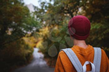 Outdoor fashion photo of young beautiful asian lady surrounded autumn forest in mountains. Portrait of romantic hipster female, Warm autumn weather, calm scene. Wanderlust photo series.