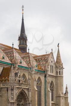 Detail of ornate carving and roof tiles on Mattias Church in Buda, Budapest, Hungary