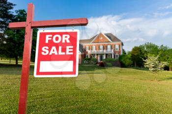 For Sale realtor sign in front of large brick single family house in expansive grass yard for real estate opportunity