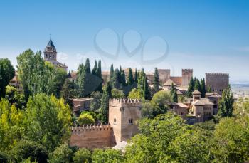 View of Nasrid Palace and church from gardens of Generalife in Alhambra in ancient city of Granada in Andalucia, Spain, Europe