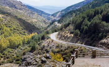 View down the winding A337 road from the Puerto de la Ragua mountain pass over the Sierra Nevada mountains in Andalucia, Spain