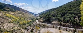 Panoramic high resolution image of the winding A337 road from the Puerto de la Ragua mountain pass over the Sierra Nevada mountains in Andalucia, Spain