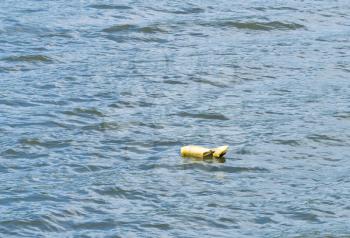 Yellow life preserver abandoned and floating down the river with nobody there