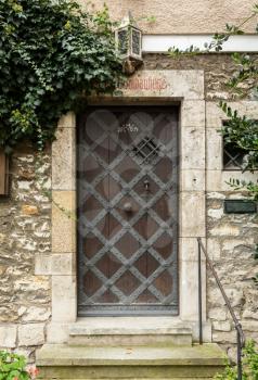 Iron clad wooden entrance door in the medieval town of Regensburg, Bavaria, Germany