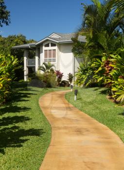 Pathway leads through tropical plants at hotel or timeshare holiday vacation resort