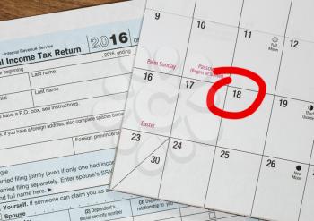 Calendar on top of form 1040 income tax form for 2016 showing tax day for filing is April 18 2017