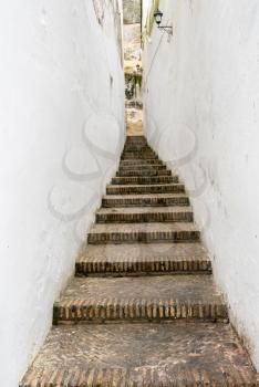 Narrow brick steps and pathway in Arcos de la Frontera near Cadiz in Spain