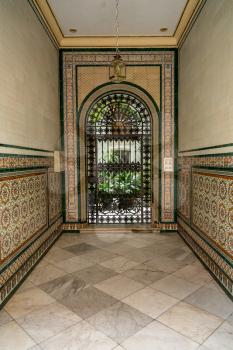 Cast iron gate to garden courtyard on Calla Ancha street in city of Cadiz in Southern Spain