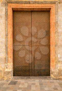 Large leather covered door in building in Valencia, Spain