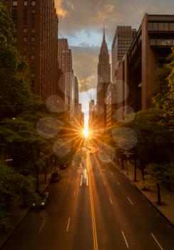 Sun setting along the length of 42nd street in New York city known as Manhattanhenge