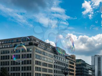 Soap bubbles reflect offices in Gendarmenmarkt square in Berlin, Germany